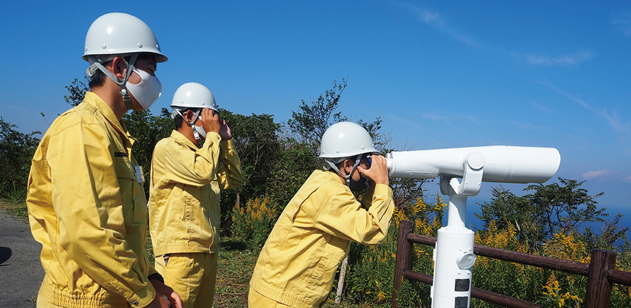 Interns look through a telescope during a chimney tour